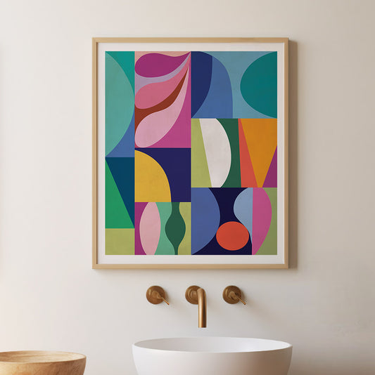 Colorful abstract art print on a wall above a sink with gold fixtures.