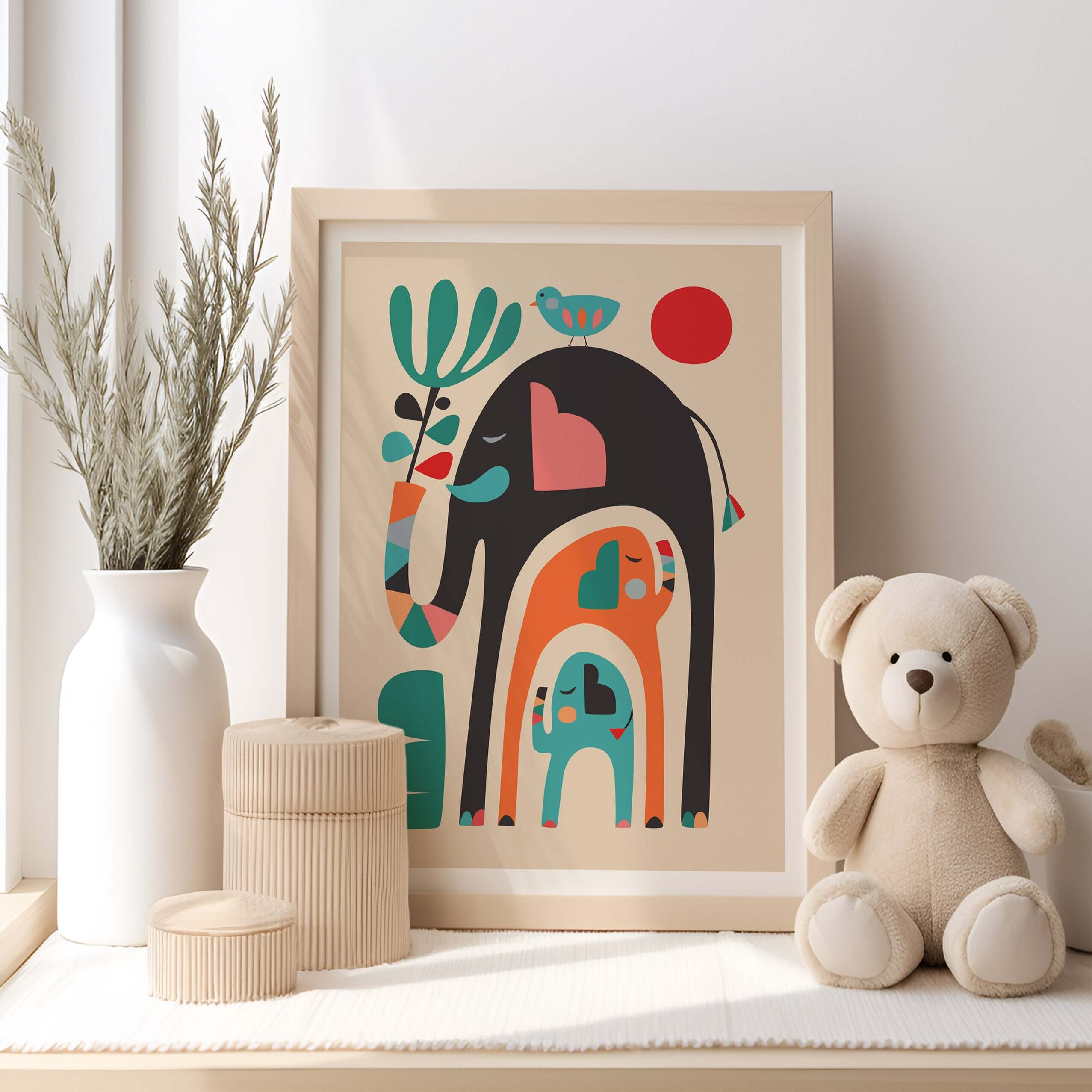 Teddy Bear sitting near framed picture, with 3 elephants print displayed.