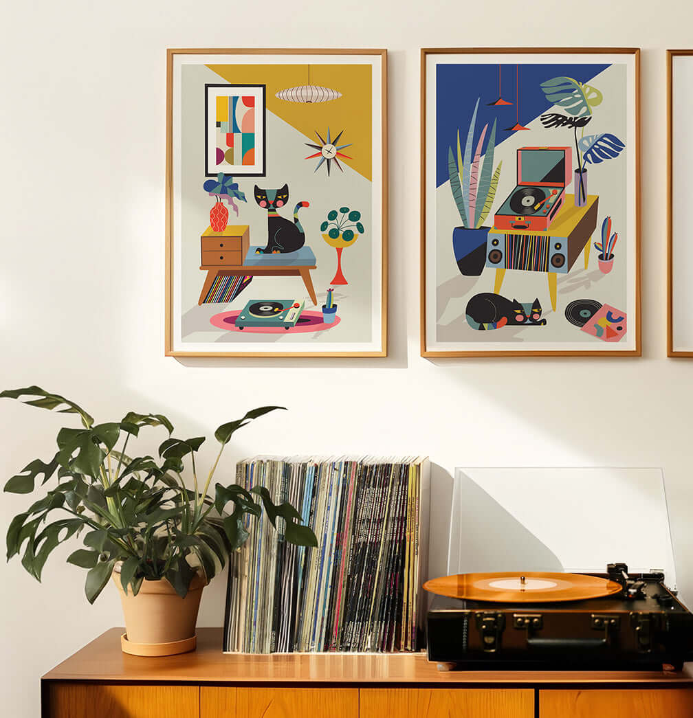 Wall adorned with three framed art prints featuring retro cat and record player designs.