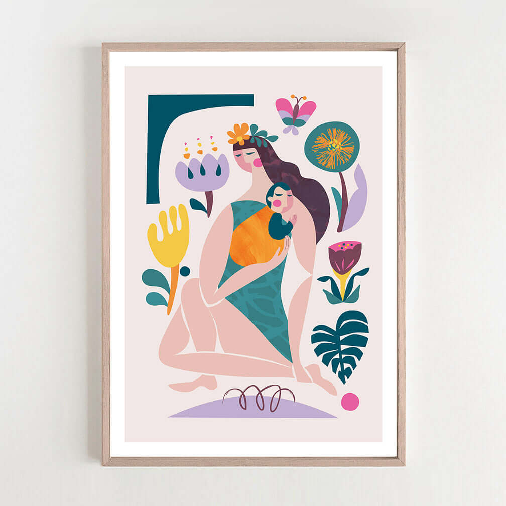  A framed art print featuring a woman is holding a baby and surrounded by vibrant flowers.