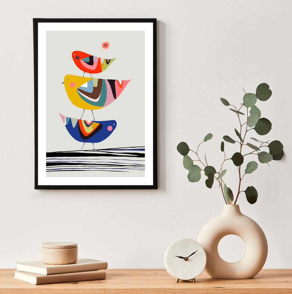  Three stacking birds framed art add a touch of whimsy to the scene.