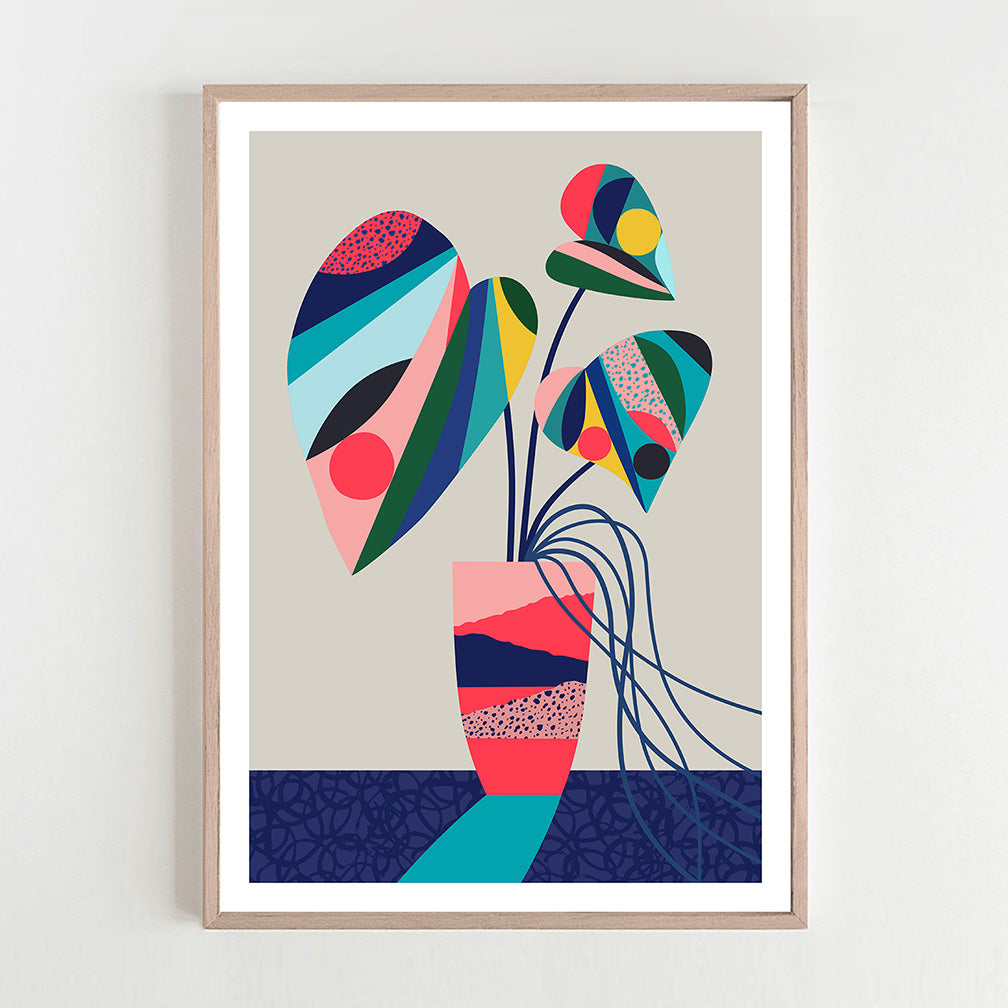 Abstract monstera plant art print in a frame on a white wall.