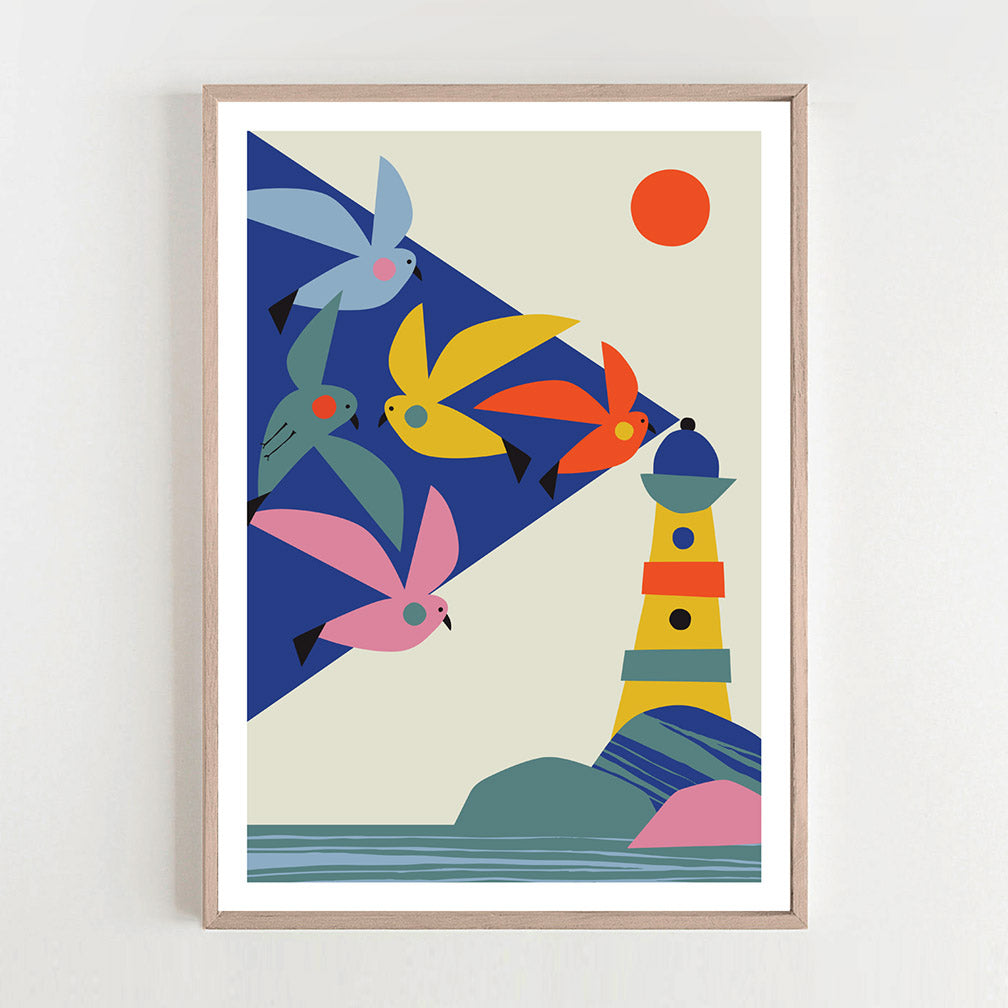 Seagulls soaring above a lighthouse in a framed print.
