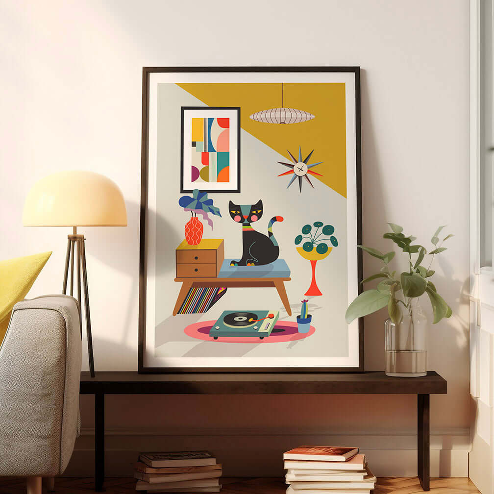 A framed art print of a cat sitting on a chair, with a record player print in the background.