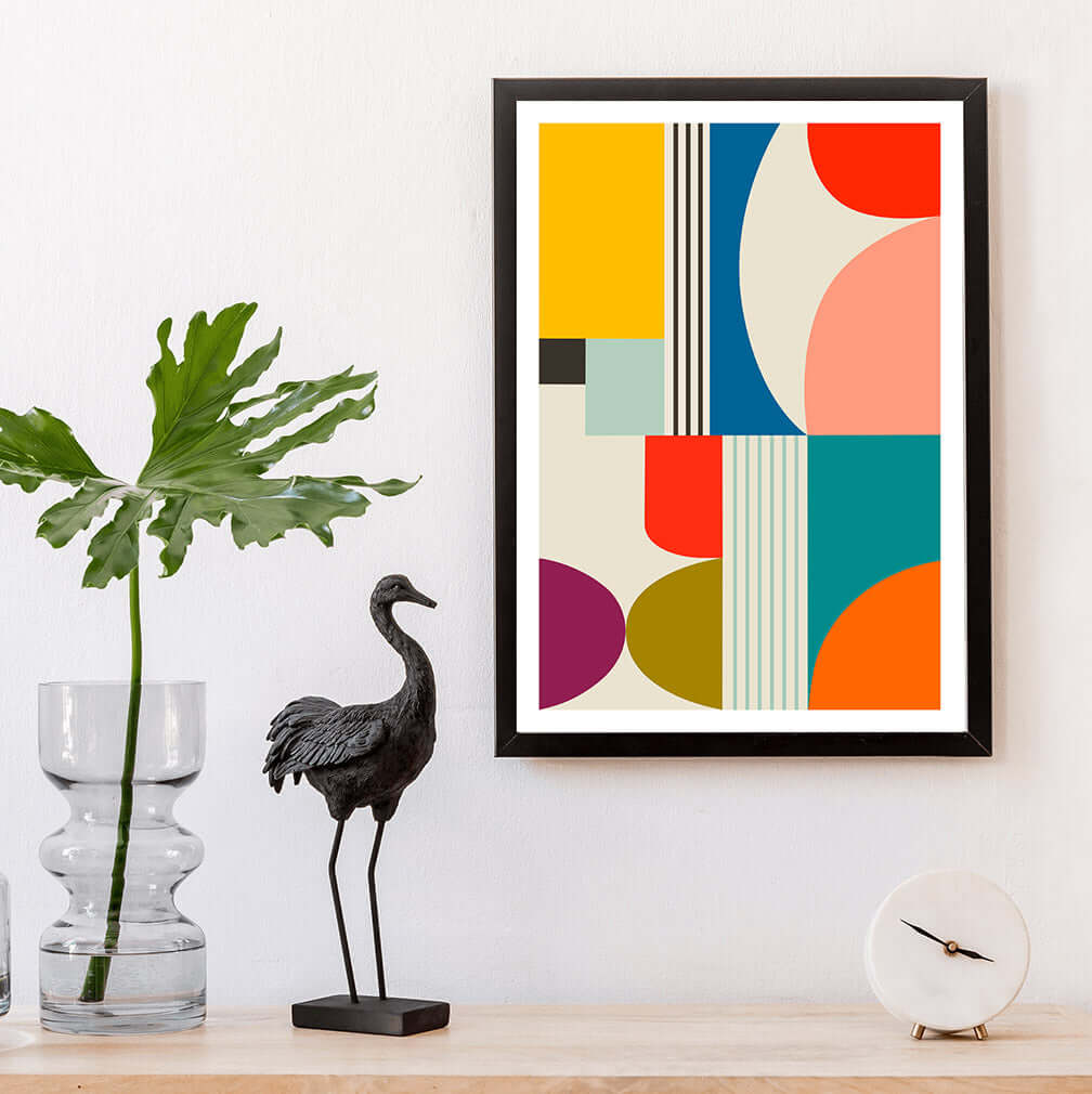 Eye-catching framed mid-century print featuring a burst of colorful shapes and patterns."