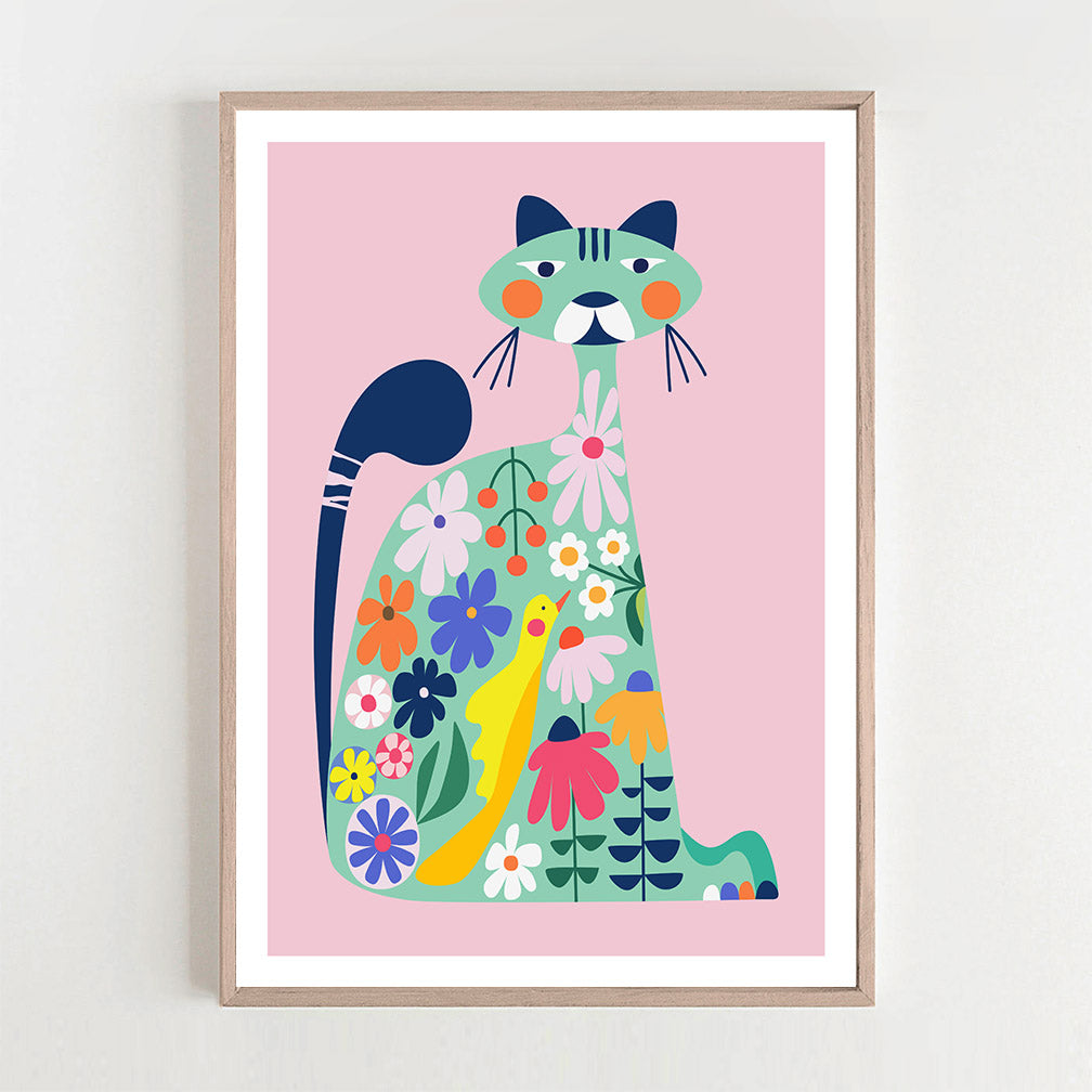 Adorable cat art print in a pink background and framed on a wall.