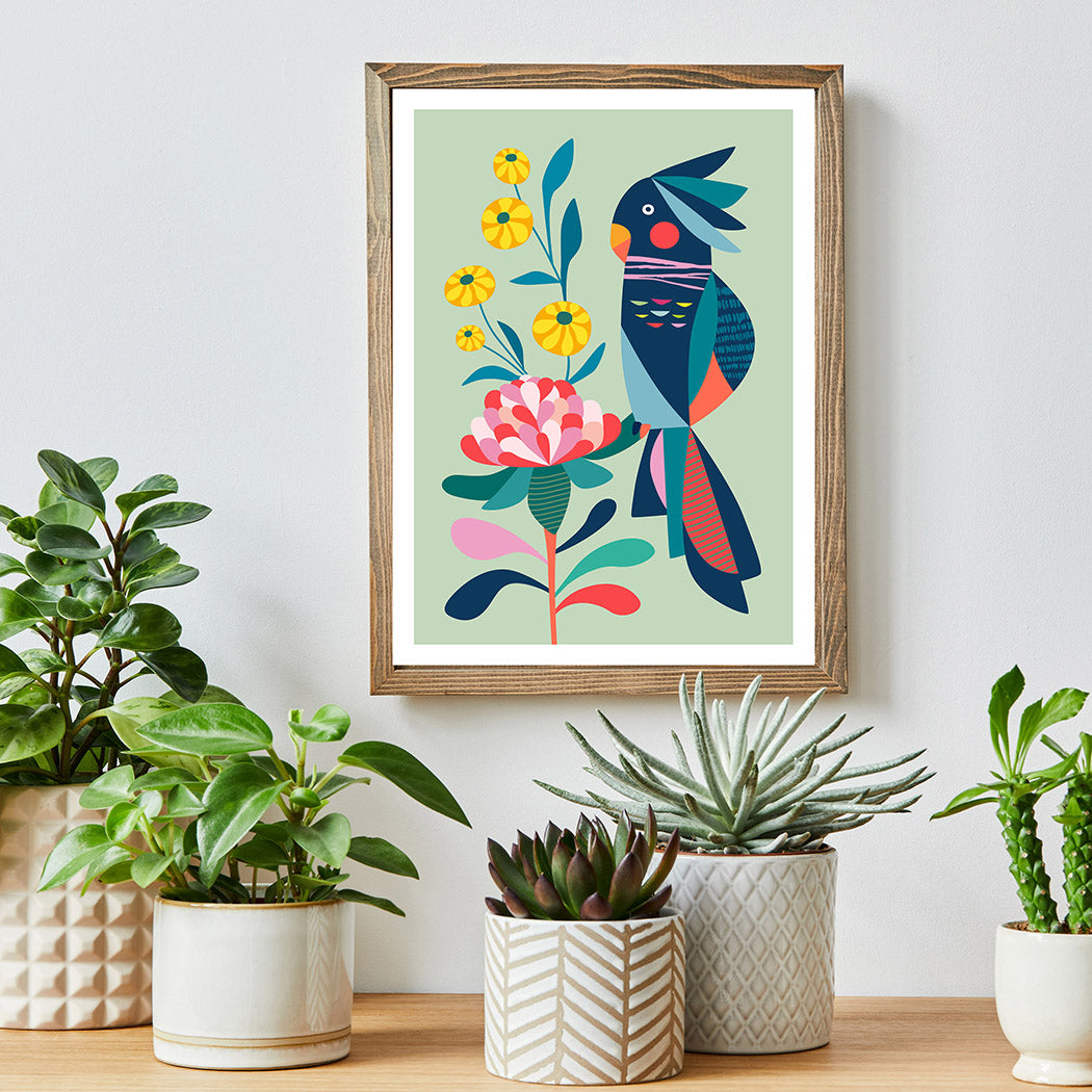 A vibrant art print of a cockatoo and flowers adorns the wall, adding a burst of color to the room.