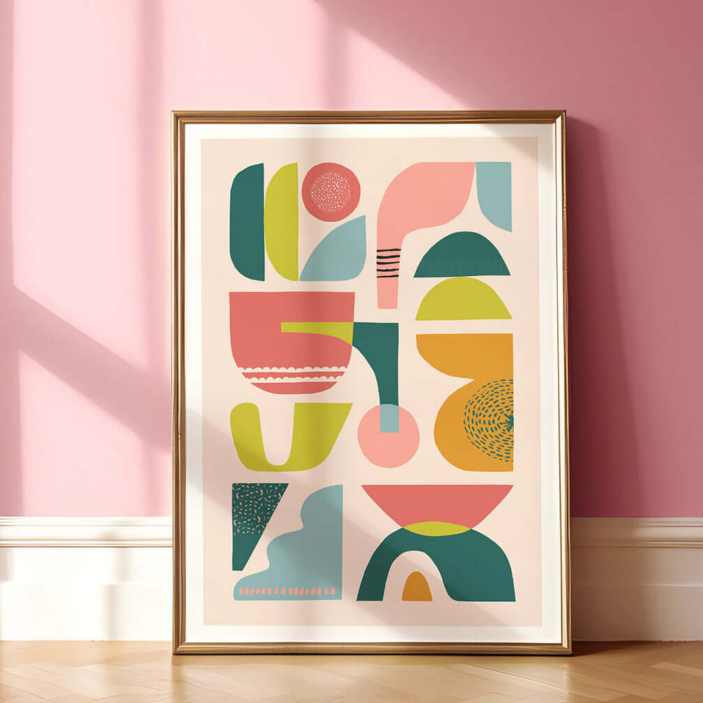Abstract geometric art print in a frame next to the pink wall.