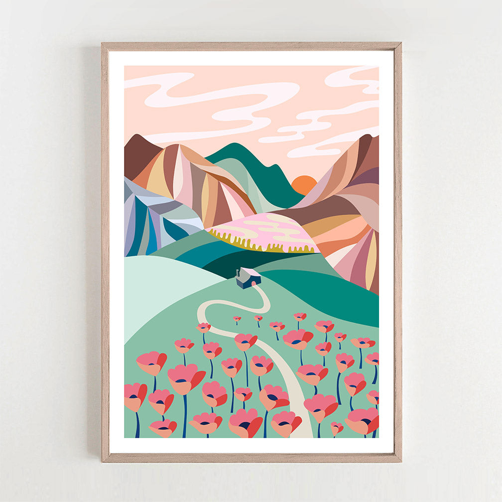A mountains & poppies print hanging on the wall.