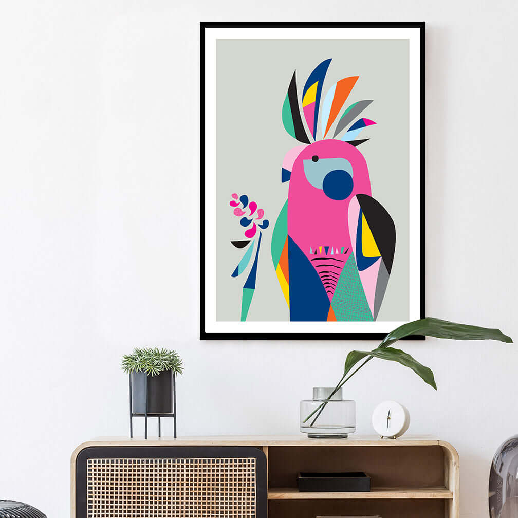 Colorful Galah bird art print on white wall.