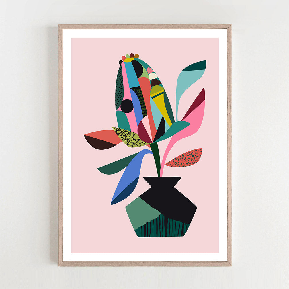 A vibrant abstract Banksia art print in pink and blue hang on the wall.
