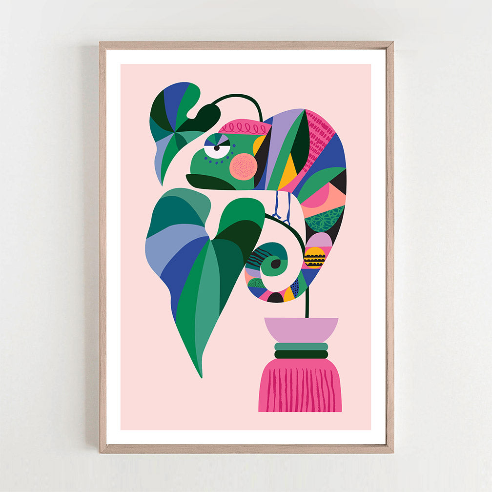 A framed art print of a plants and a chameleon.