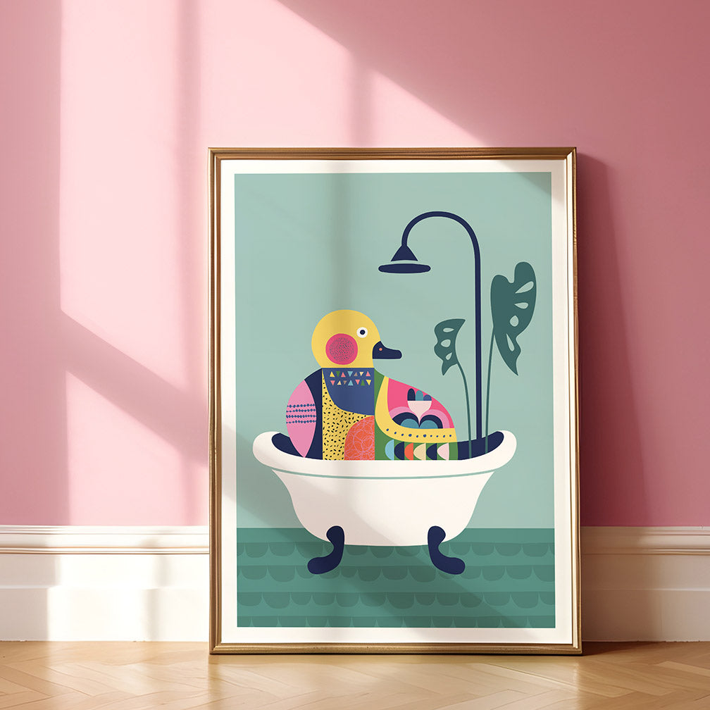 A duckie in a bathtub framed print next to the pink wall.