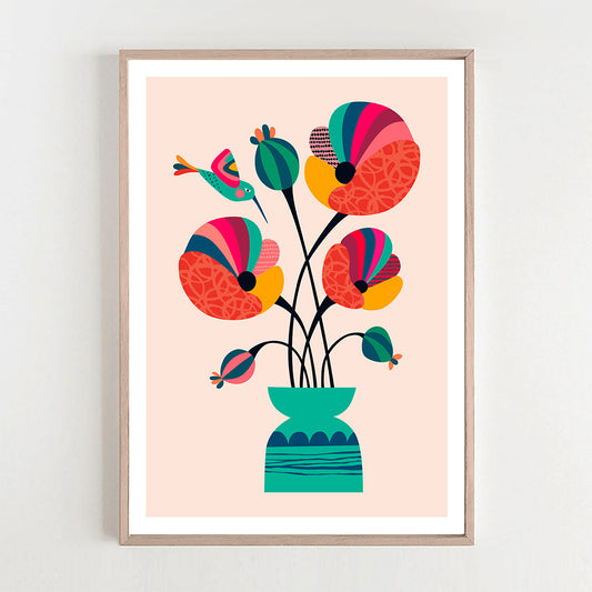 Vibrant poppies and hummingbird art print hang on the wall.