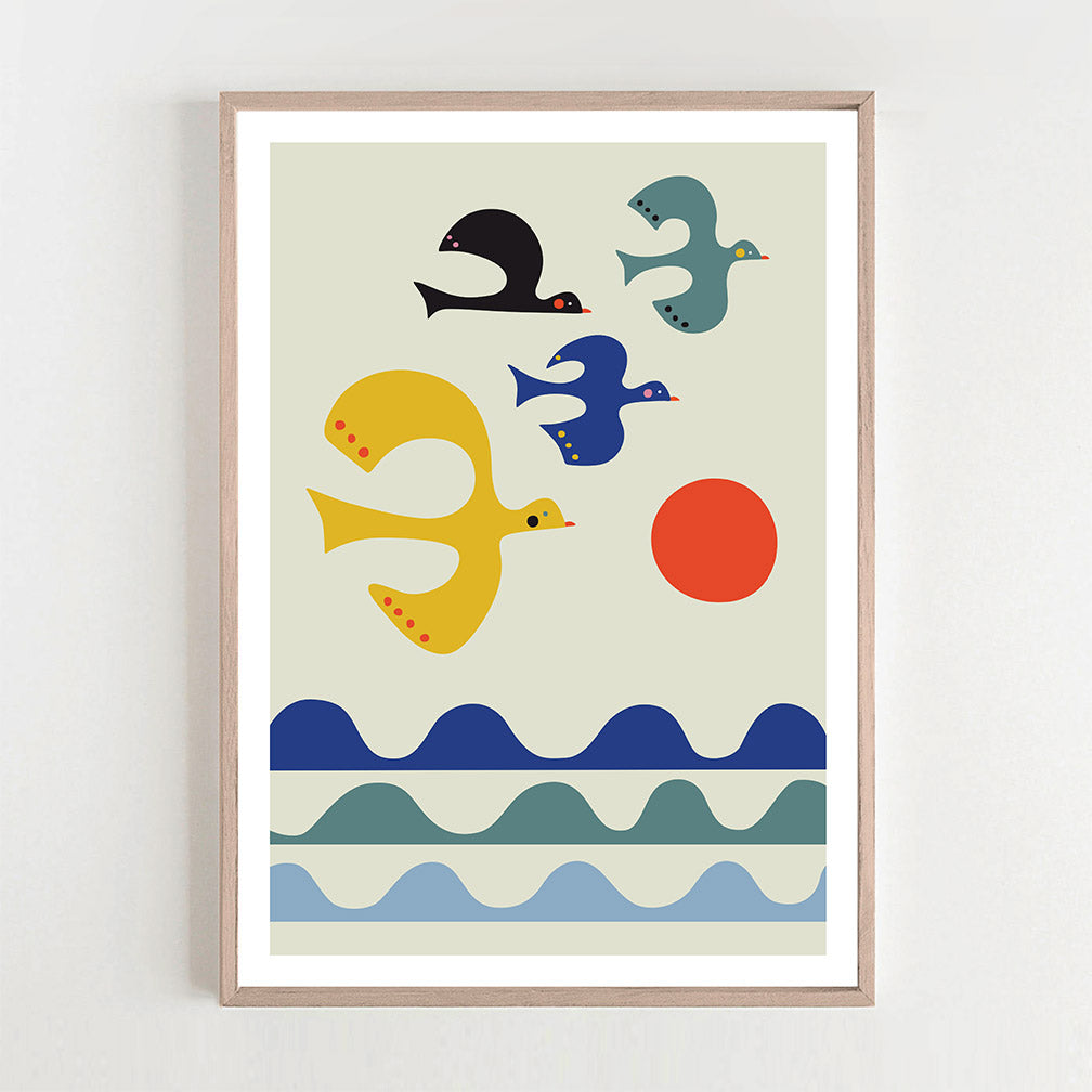 Sunset art print featuring a flock of birds flying over the ocean.