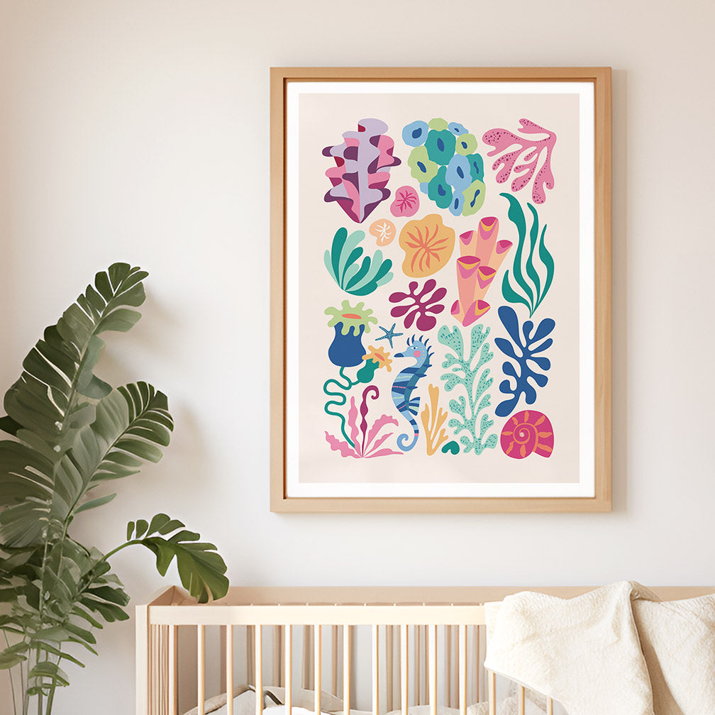 A vibrant framed art print featuring colorful  seaweed with corals, sea horse, and seashell art in a nursery room.