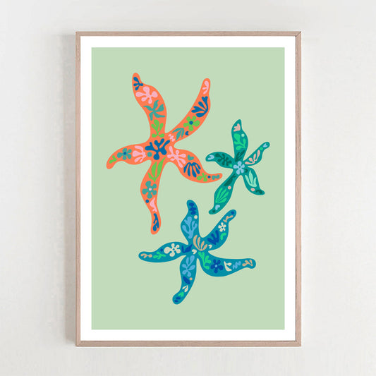 Colorful flowers and leaves in a framed art print, highlighted by a starfish, bringing a lively vibe to your home or office.