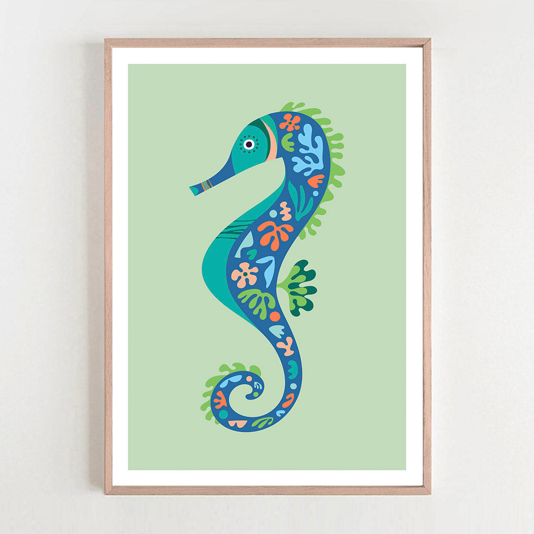 A vibrant seahorse art print in a stylish frame, hanging on a wall, adding a pop of color to the room.  