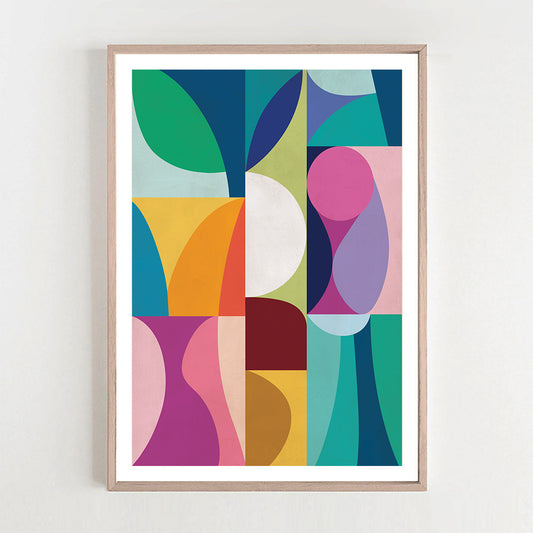 Framed abstract art print with colorful geometric shapes on a white wall