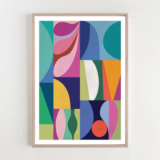Framed abstract art print with colorful geometric shapes on a white wall