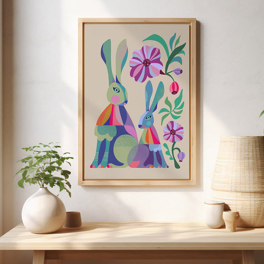 Framed artwork of colorful rabbits and flowers on a wall above a wooden shelf with decor items.