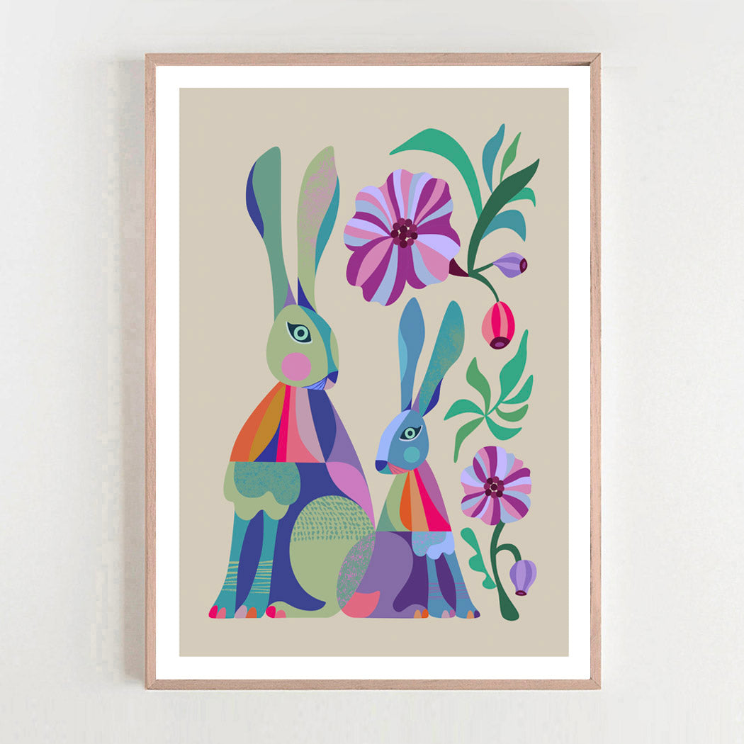 Framed artwork with colorful abstract rabbits and flowers on a beige background