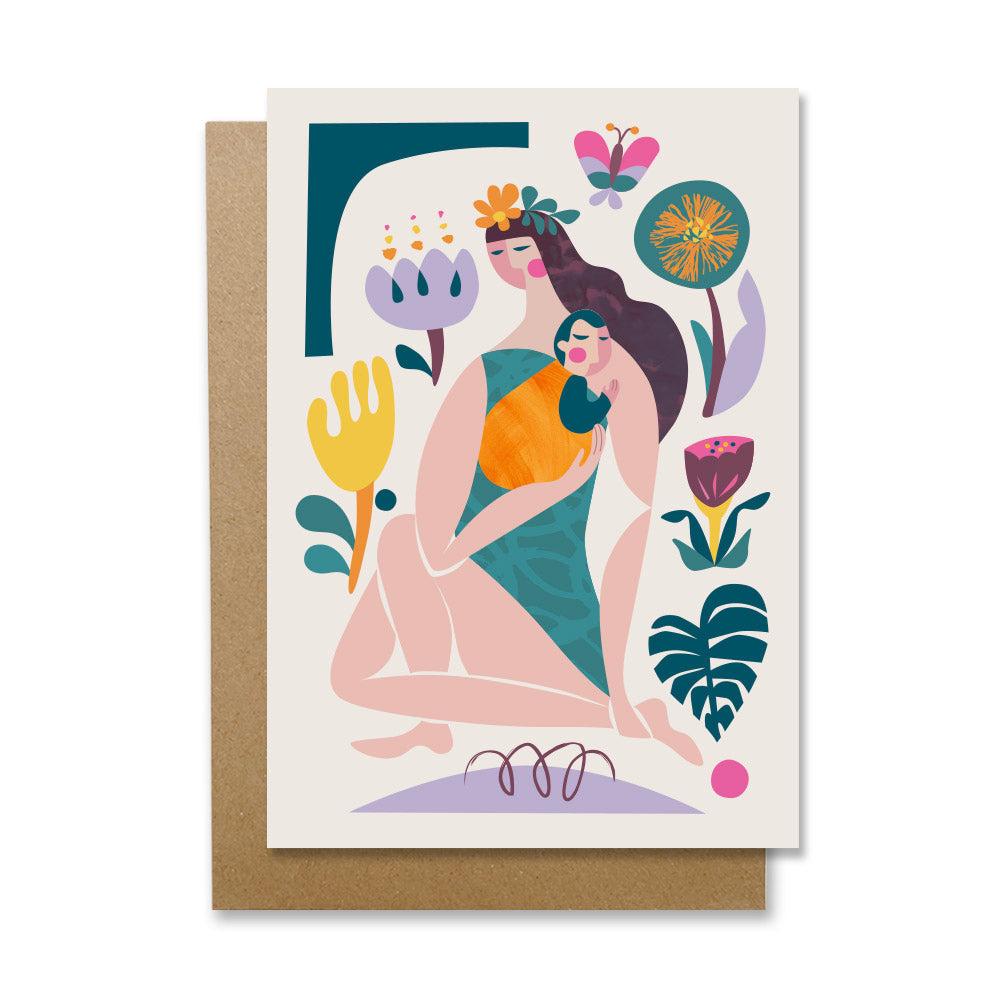 A greeting card featuring a woman is holding a baby and surrounded by vibrant flowers.