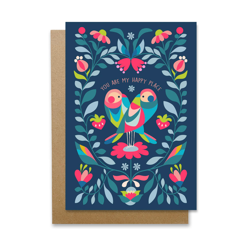A colorful greeting card with two love birds perched on a branch, surrounded by hearts and flowers.