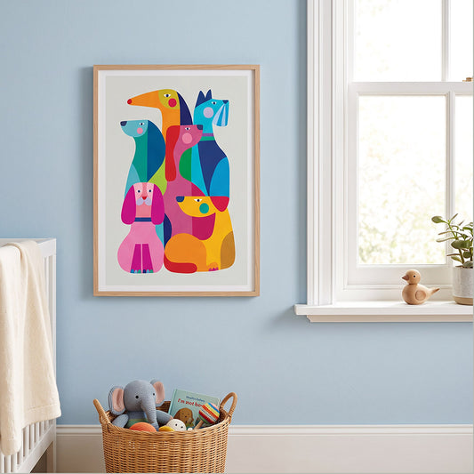 A framed colorful art print featuring stylized dogs in bright geometric shapes, hanging on a light blue wall in a nursery setting next to a window.